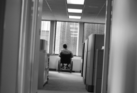 Black and white photo of employee in a wheelchair