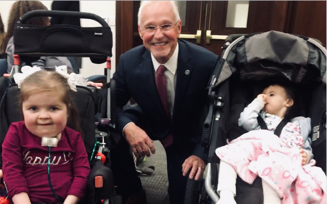 Representative Ron Travis with two young girls