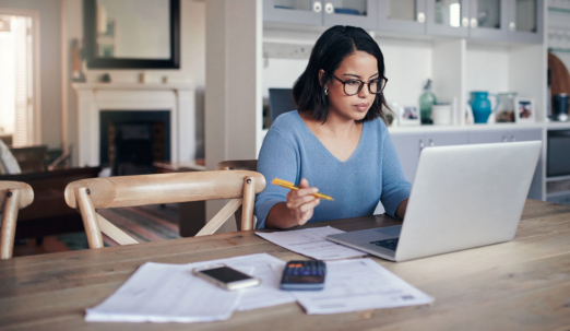A woman works from her kitchen table