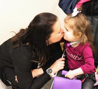 Tori and her daughter share a kiss at Disability Day on the Hill in 2019.