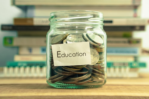 Jar with coins in it. Label reads "Education"