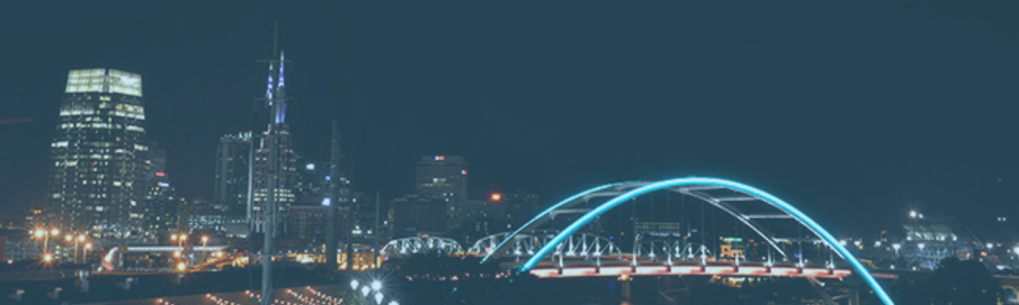Nashville skyline with bridge lit up blue