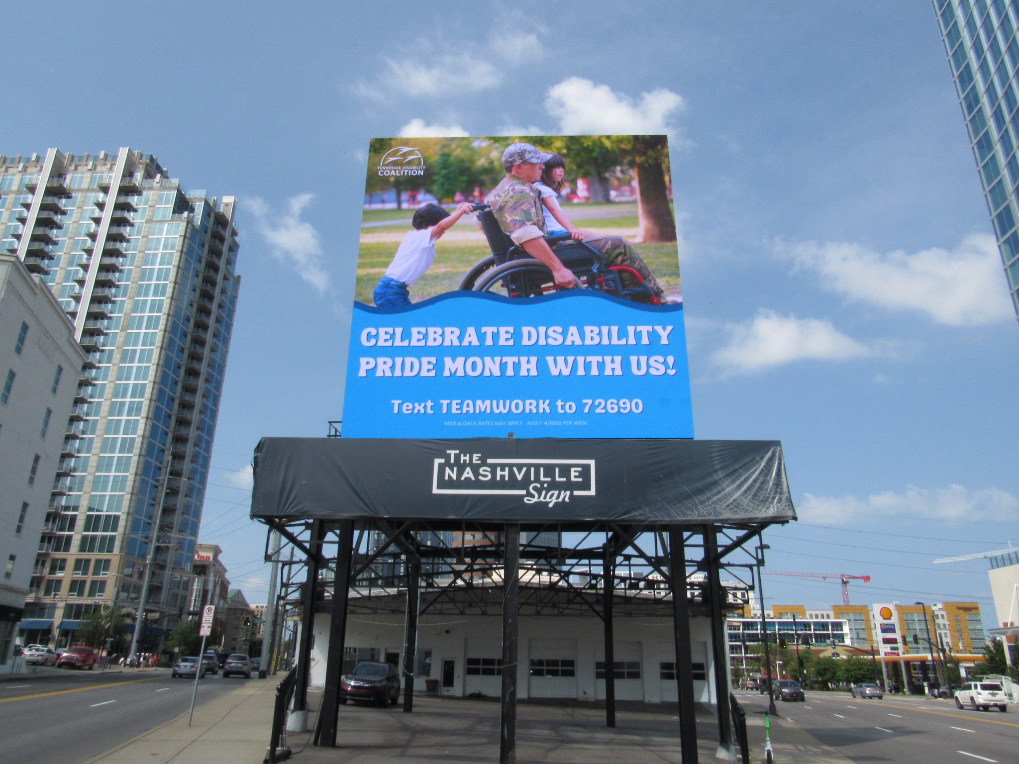 TDC's Disability Pride Month billboard displayed on a large billboard in downtown Nashville