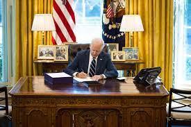 President Biden signs the American Rescue Plan in the Oval Office