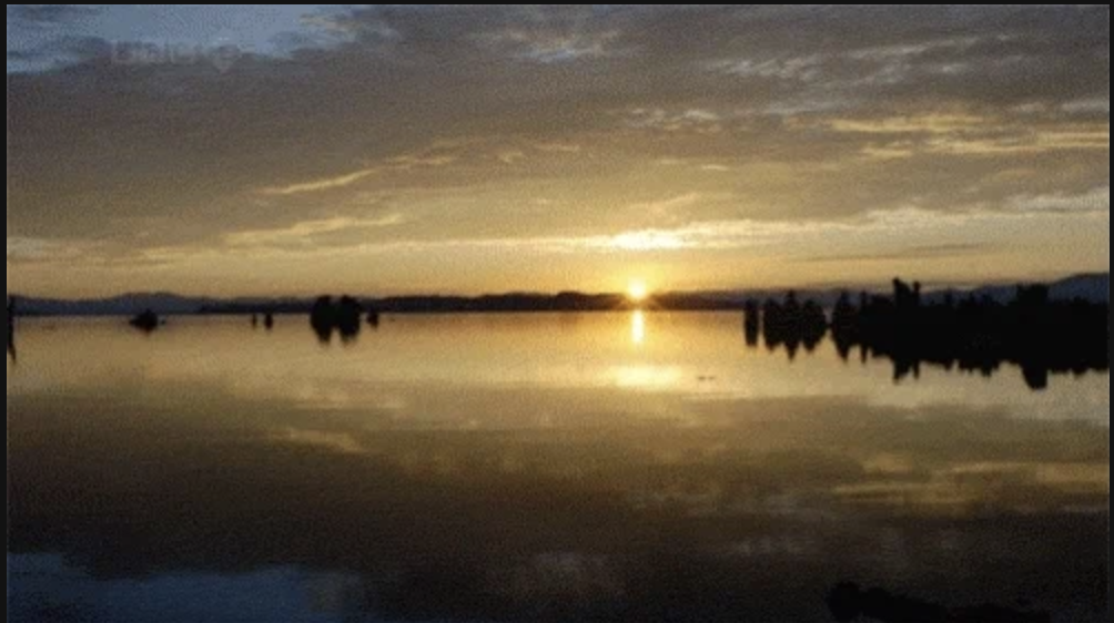 A sunrise over a lake