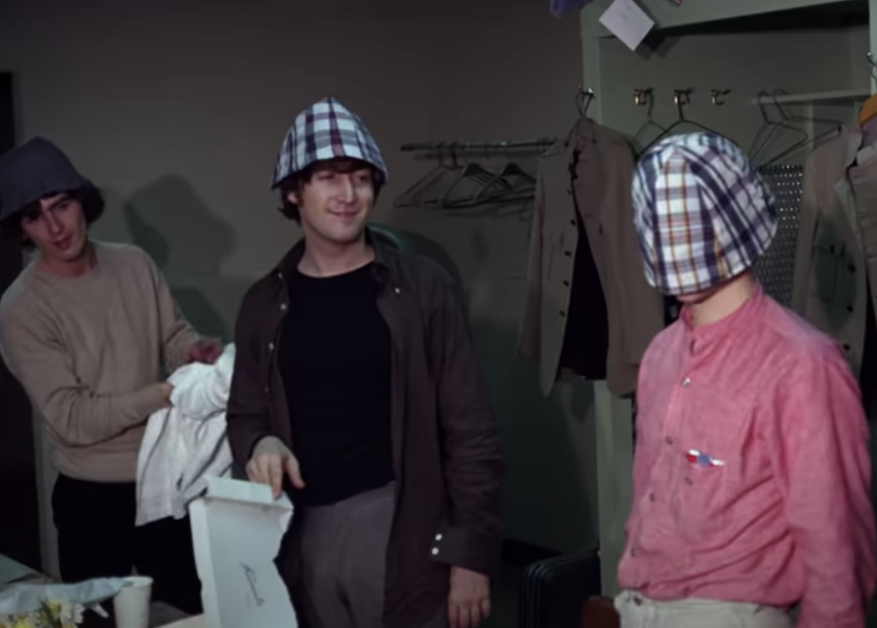 George Harrison and Paul McCartney wearing plaid bucket hats, John or Ringo has the bucket hat pulled down over his head
