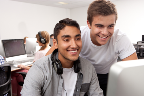 Two people looking at a computer screen.